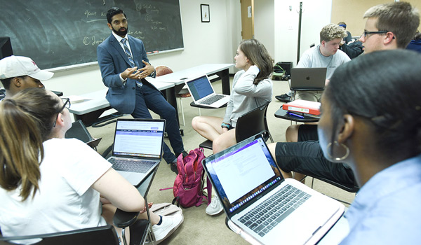 Sociology professor Dr. Brandon Vaidyanathan teaching a course on crime and justice.
