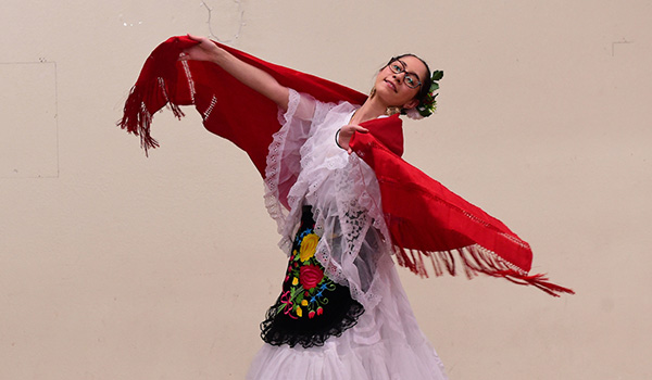 A woman performing a traditional Mexican dance.