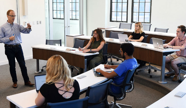 A professor teaching a business class in Maloney Hall.