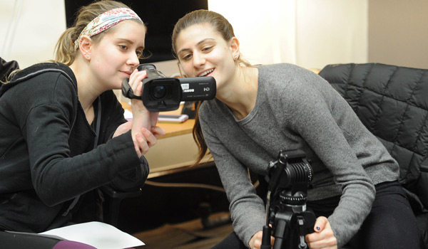 Two students reviewing the work they filmed for class.