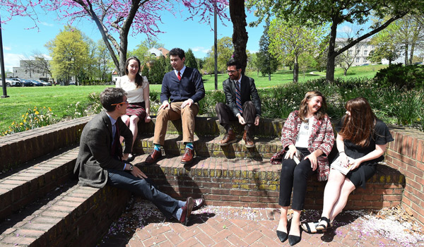 A philosophy class being held outside Aquinas Hall.
