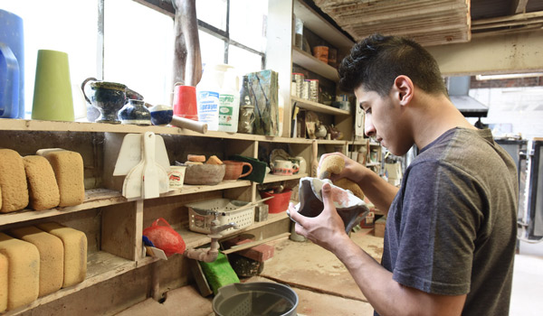 A student working on a sculpture art project.